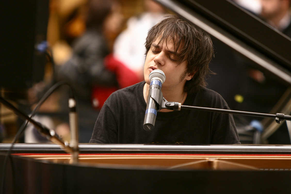 Jamie Cullum performs while playing piano