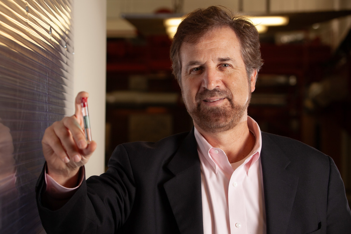 scientist holding vial