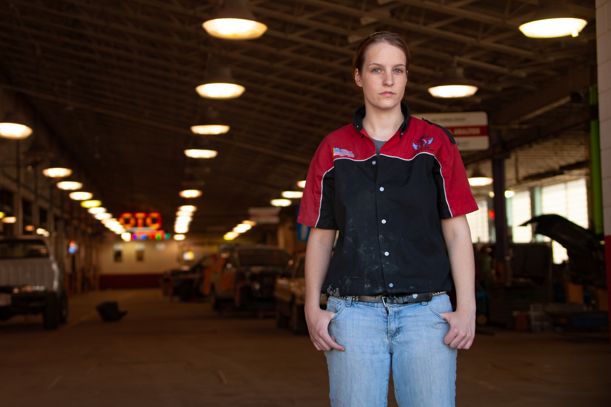 female mechanic posing at auto shop