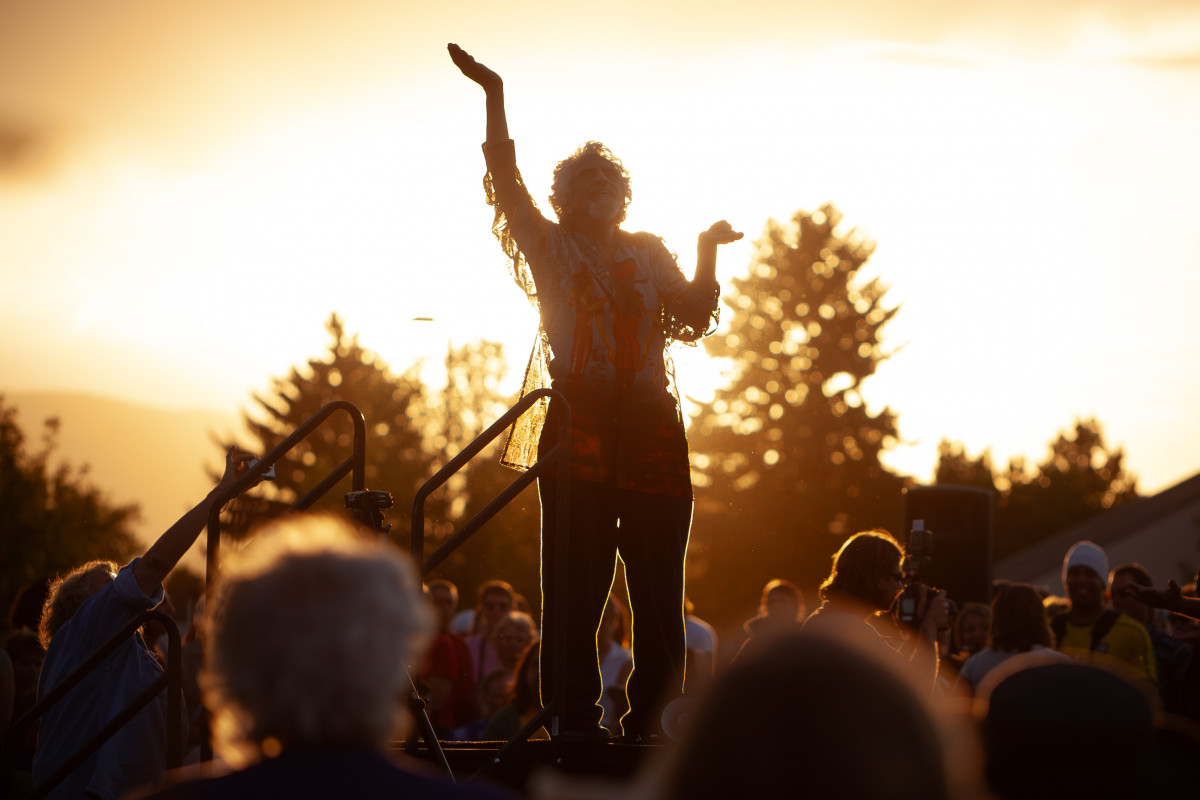 man leading drum circle with setting sun
